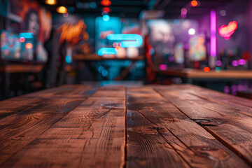 A wooden table in the foreground with a blurred background of a gaming cafÃ©. The background features rows of gaming PCs, comfortable gaming chairs, colorful LED lights, and posters of popular games. 