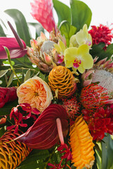 Fototapeta premium Tropical colorful floral display with protea, orchids and more