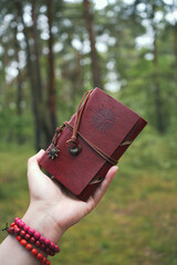 person with a little brown notebook