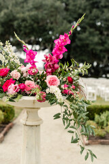 Floral arrangement in a pedestal vase with pink and white flowers