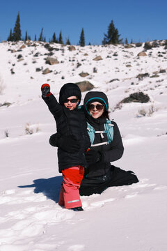 Mother and child enjoying a winter day in the snow