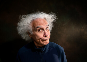 69 year old man with crazy hair making expression.