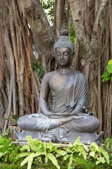 Bronze Buddha statue at a zen garden in Thailand