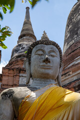 Buddha rock statue with yellow fabric at a temple in Ayutthaya