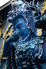 Deity statue at the Blue Temple of Chiang Rai, Thailand