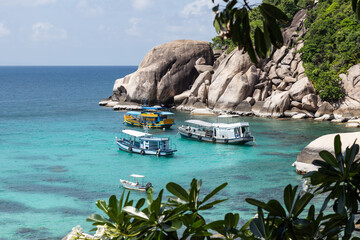 3 Diving boats, anchored at calm blue water bay in Thailand