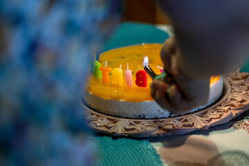 Lighting up a home-made fruity birthday cake