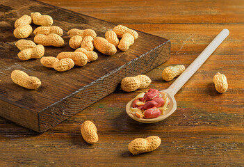Pile of peanuts on a wooden board
