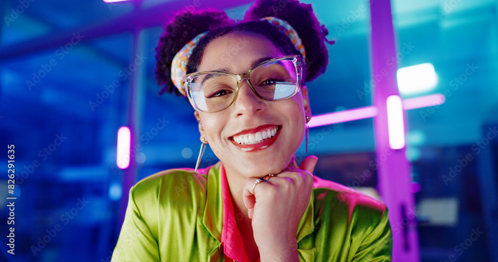 Poster Face, computer and neon with programmer woman in office at night for coding or developing. Portrait, smile or happy young game developer sitting at desk in workplace with virtual system update