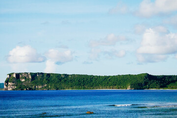 Scenic view of fluffy white clouds over sandy Tumon Beach, Guam, USA