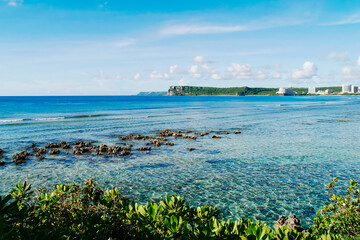Scenic view of fluffy white clouds over sandy Tumon Beach, Guam, USA