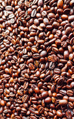 Top view of backdrop dark brown coffee beans and Textured background of freshly roasted coffee beans