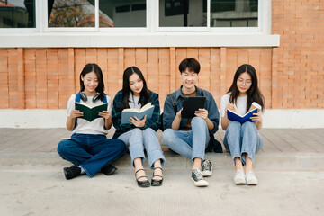 Young Asian People college students and a female student group work at the campus park in morning with her friend