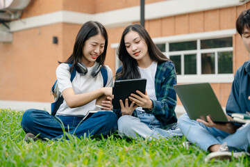 Young Asian People college students and a female student group work at the campus park in morning with her friend