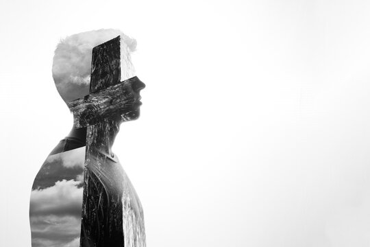 Double exposure silhouette of a man and a crucifix, Religious concept