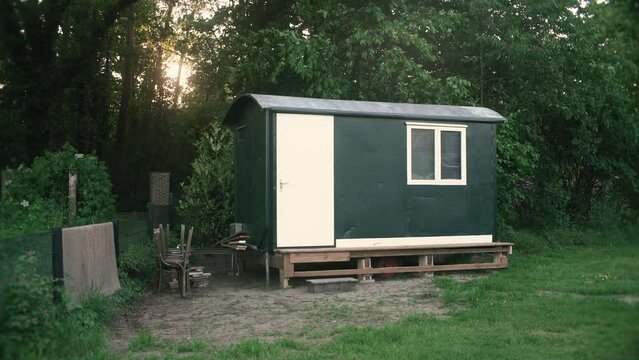 Small tiny home, shed size in a yard.
