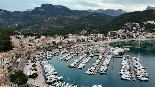 Drone shot of Port de Soller village and the port of the town of Soller at sunset in Mallorca, Spain