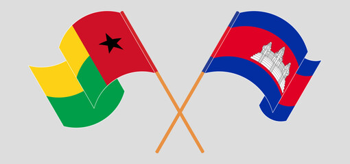 Crossed and waving flags of Guinea-Bissau and Cambodia