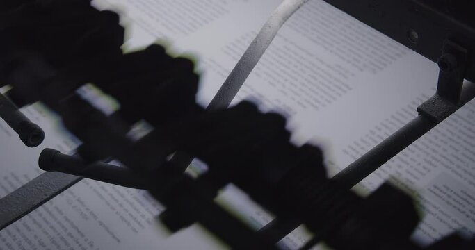 Closeup footage of an offset printing machine in printing house with blur background