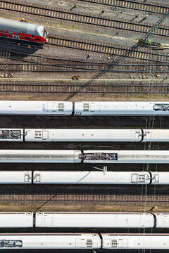 Multiple locomotives stationary on train tracks surrounded by parallel tracks: Frankfurt, Germany