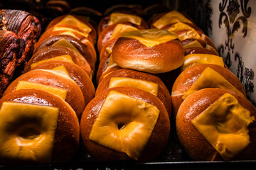 Closeup shot of a variety of freshly baked goods in a tray illuminated by warm light