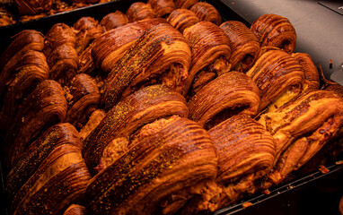 Closeup shot of a variety of freshly baked goods in a tray illuminated by warm light