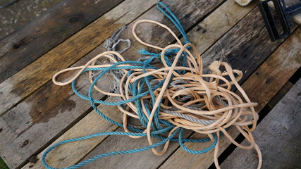 Closeup shot of messy rope and string entangled on a wooden surface