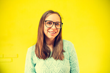 Woman With Glasses Smiling for the Camera. Her expression is joyful and engaging