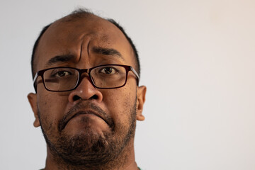 head shot of asian man with mocking expression
