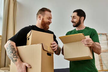 A gay couple holds boxes in their new home, symbolizing a fresh start filled with love and...