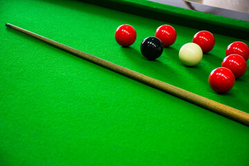 pool cues and balls sitting on a green table with red, white, and blue