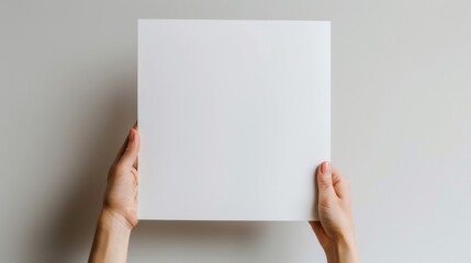 Hand holding white paper in corner, design space