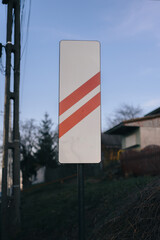 a close up of a street sign in a field outside