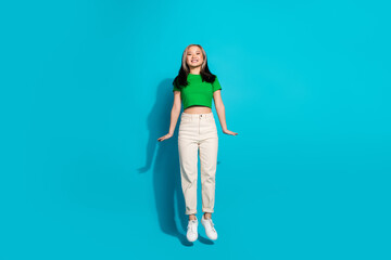 Full body portrait of pretty young girl jump empty space wear t-shirt isolated on turquoise color background