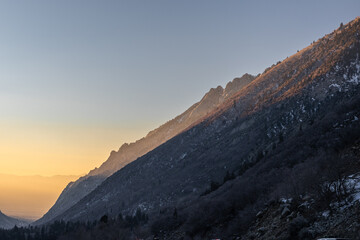 Mountains of Little Cottonwood Canyon in Utah at sunset with snow