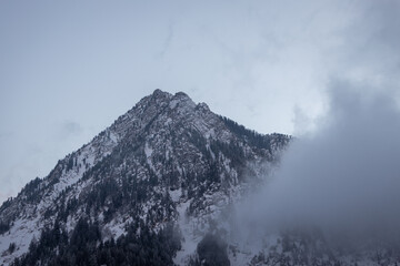 Mountains of Little Cottonwood Canyon in Utah at sunset with snow