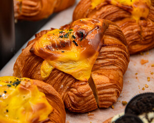Closeup shot of savory croissants displayed on a bakery shelf