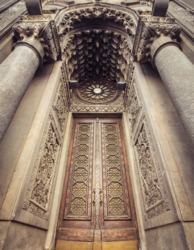 The entrance gate of Karaite Kenesa (synagogue). symmetric wide-angle image of tall wooden doors of old religious building. Kyiv, Ukraine - March 09, 2014.