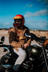 a person riding a motorcycle on a desert field next to a motor bike