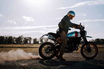 a man in a helmet riding a motorcycle on the road