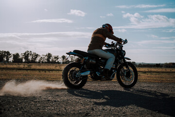 a man riding a dirt bike in a field on a sunny day