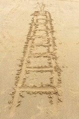 Vertical shot of a ladder-shaped pattern imprinted on sandy beach