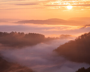 Scenic landscape with hills in the sea of clouds