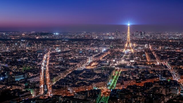 the city skylines at night seen from the sky in paris