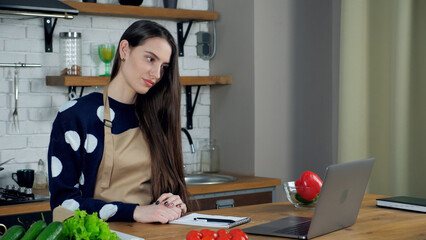 Beautiful woman housewife in beige apron listen chef teacher, study remote online video webcam...
