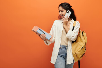 Young indian woman engaging in a phone call while carrying a backpack.
