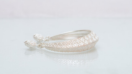 Handmade silver jewelry display on white background