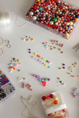 Friends forever written with colorful beads. Jewelry making supplies on the table. Making...