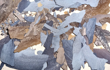 Abstract sea shore camouflage texture.   Mixed brown, gray and blue lime plates. Selective focus