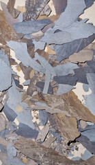 Abstract sea shore camouflage texture.   Mixed brown, gray and blue lime plates. Selective focus